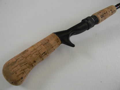 A close-up of the G. Loomis Custom Pistol Grip CR664 IM6 5'6" Heavy used casting rod in fair condition—ideal for those interested in our Rod and Reel Trade-In Program to earn store credit for your used gear.