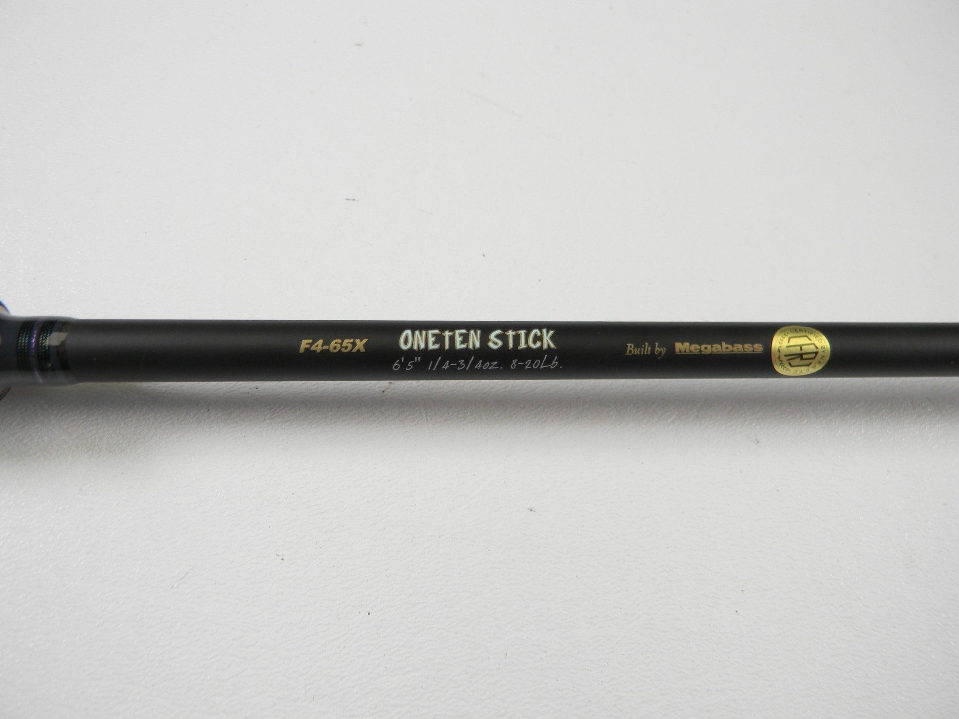 Close-up of the Megabass Destroyer P5 F4-65X OneTen Stick 6'5" Medium Used Casting Rod in excellent condition—ideal for our Rod and Reel Trade-In Program or earning store credit on pre-owned Megabass gear.