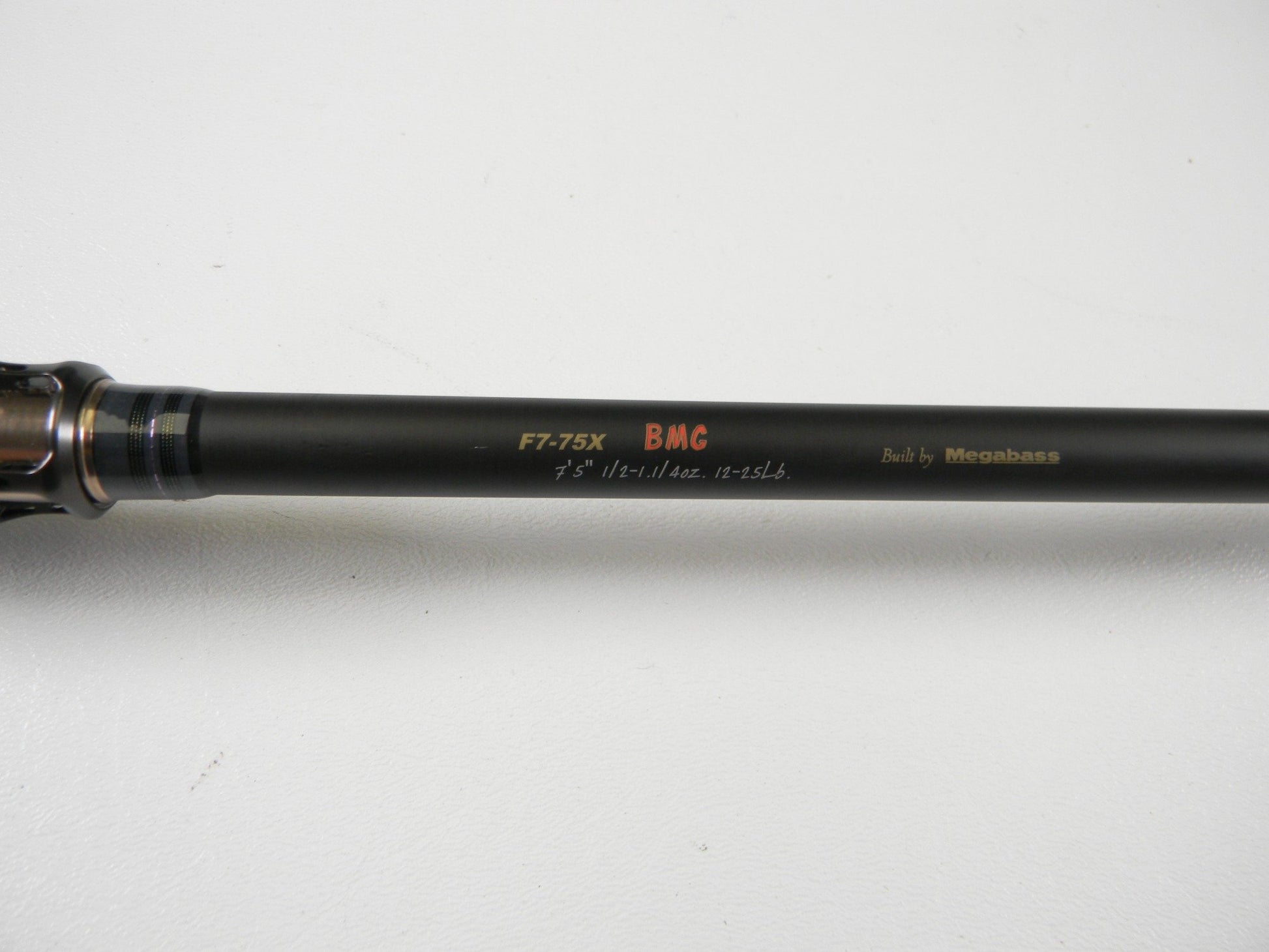 A close-up of a Megabass Destroyer P5 F7-75X BMG 7'5" Heavy Used Casting Rod in excellent condition—ideal for upgrading through our Rod and Reel Trade-In Program.