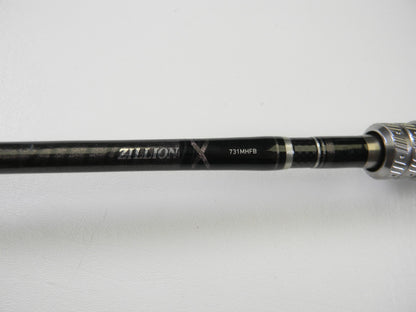 A close-up of the Daiwa Zillion ZIL731MHFB 7'3" Medium Heavy Used Casting Rod in excellent condition displays "ZILLION X 731MHFB" on its black and silver handle, ideal for the Rod and Reel Trade-In Program, against a white background.