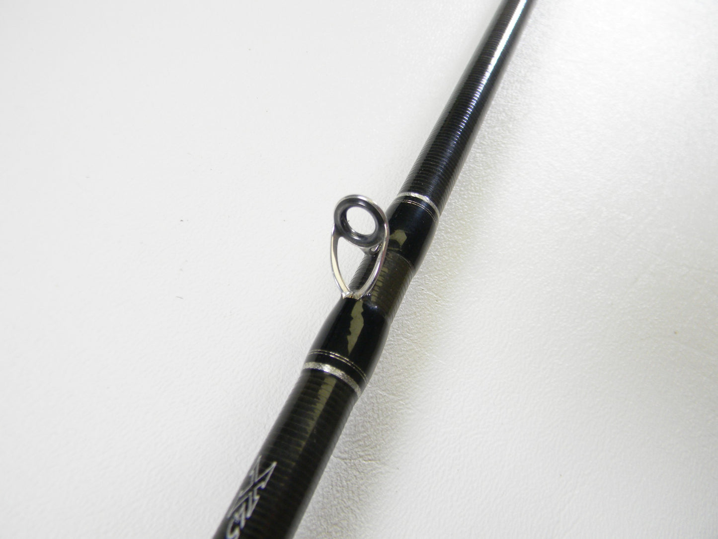 A close-up of the Daiwa Zillion ZIL731MHFB 7'3" Medium Heavy Used Casting Rod in excellent condition showcases its metal line guide—ideal for upgrading your gear through our Rod and Reel Trade-In Program for store credit.