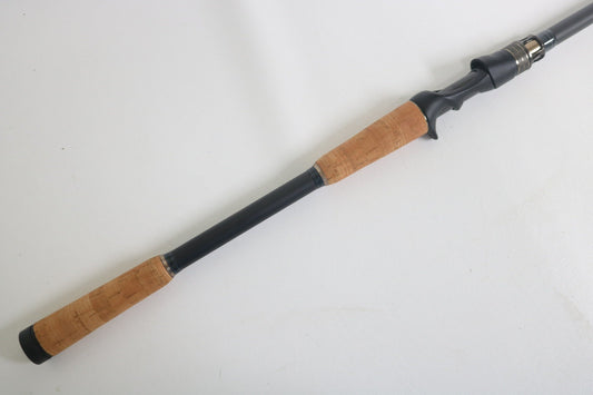 The Megabass Destroyer P5 F7.1/2-76X Used Casting Rod by Megabass, featuring cork handles on both ends and a black reel seat, is shown against a plain white background in excellent condition.