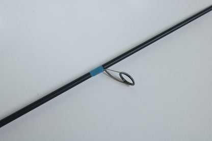 A close-up of a G. Loomis NRX+ 802S JWR Used Spinning Rod in mint condition, featuring a metal guide ring and blue wrap—ideal for anglers seeking quality used gear or exploring our rod and reel trade-in program.