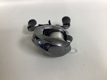 A Shimano Chronarch MGL CHMGL150HG used baitcasting reel in excellent condition with black handles and white fishing line, shown on a plain white surface.