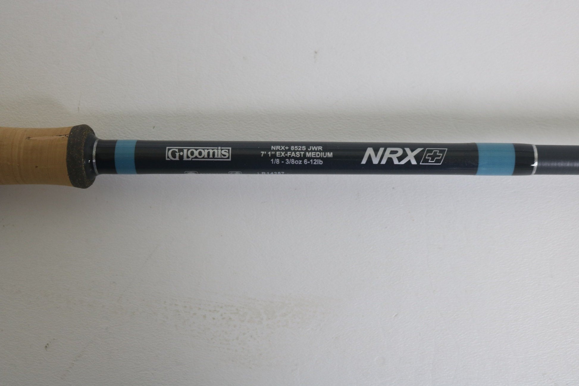 Close-up of a G. Loomis NRX+ 852S JWR Used Spinning Rod in excellent condition on a white background. Trade in your used gear for store credit during our Rod and Reel Trade-In event!.