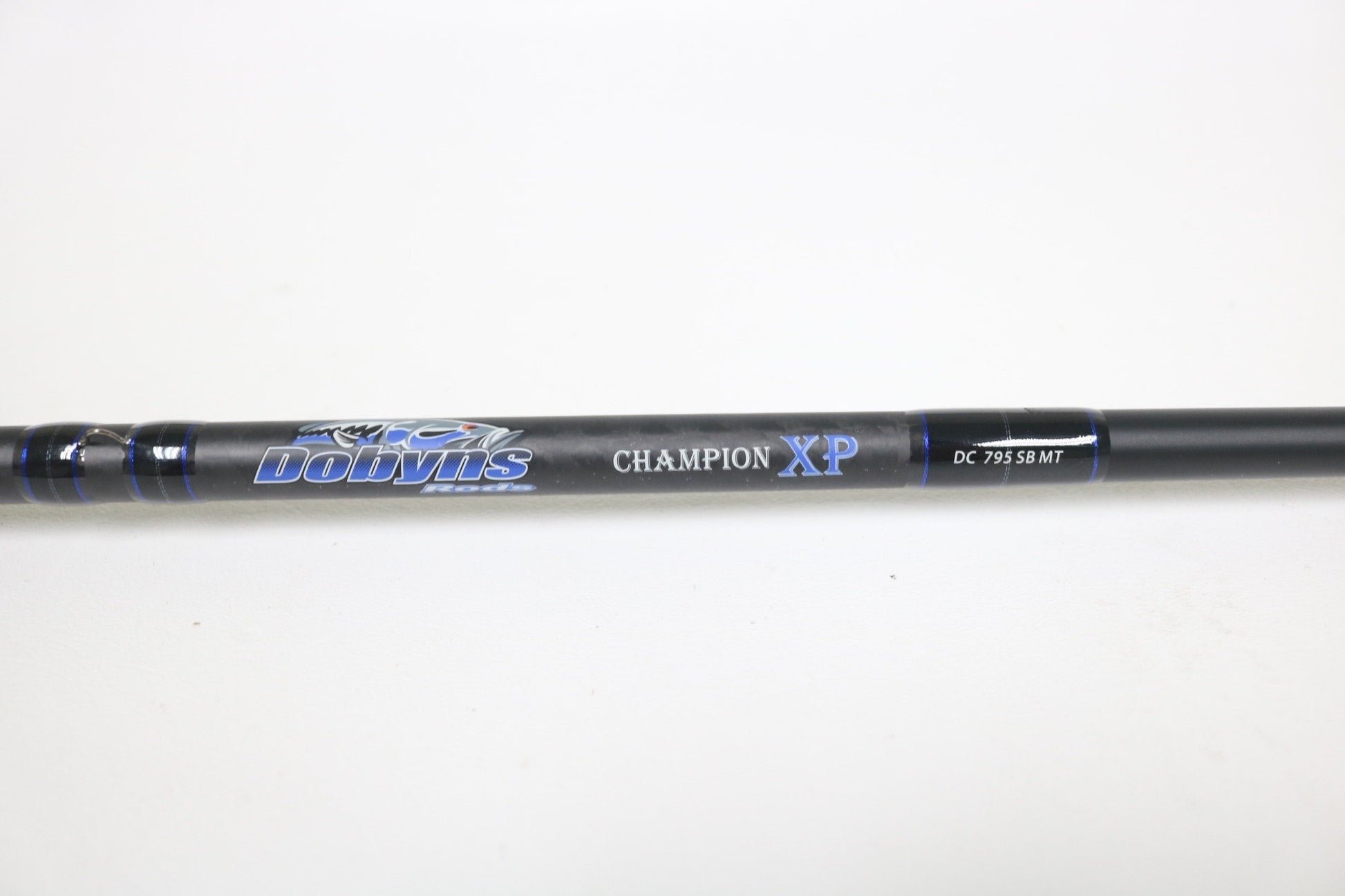 Close-up of a Dobyns Champion XP DC 795SB MT 7'9" Medium Heavy Used Casting Rod in excellent condition, displaying the brand logo and model—ideal for trade-ins or those shopping for quality used Dobyns fishing gear.