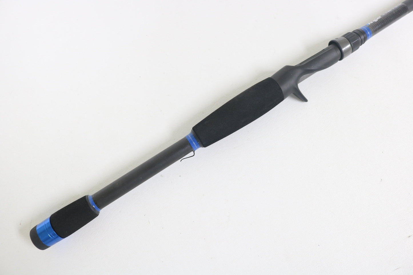 A close-up of the Alpha Angler Mag-Hitter 7'11" Magnum Heavy Used Casting Rod in excellent condition, with blue accents and a foam handle—ideal for trading in used gear for store credit via our rod and reel trade-in program.