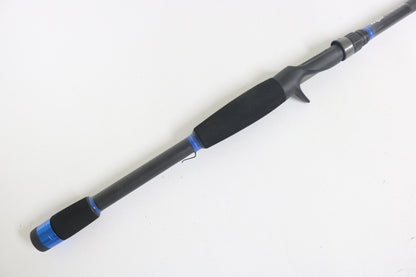 A close-up of the Alpha Angler Mag-Hitter 7'11" Magnum Heavy Used Casting Rod in excellent condition, with blue accents and a foam handle—ideal for trading in used gear for store credit via our rod and reel trade-in program.