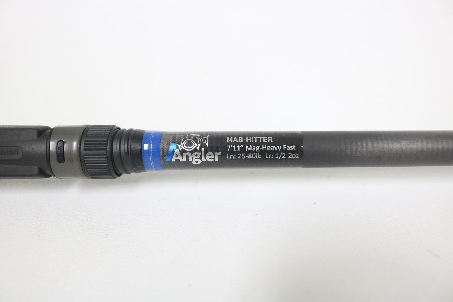 A close-up of the Alpha Angler Mag-Hitter 7'11" Magnum Heavy Used Casting Rod—excellent condition, with a black handle and blue ring near the reel seat—ideal for our rod and reel trade-in program.