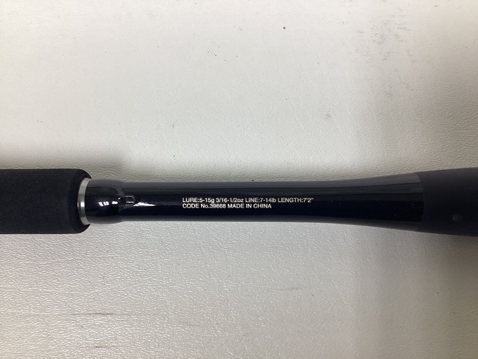 A close-up of a Shimano Zodias ZDC72MLBFSA Used Casting Rod in excellent condition, showing white specs like lure weight, line weight, and 7'2" length on the black rod with "Made in China," set against a plain white background.