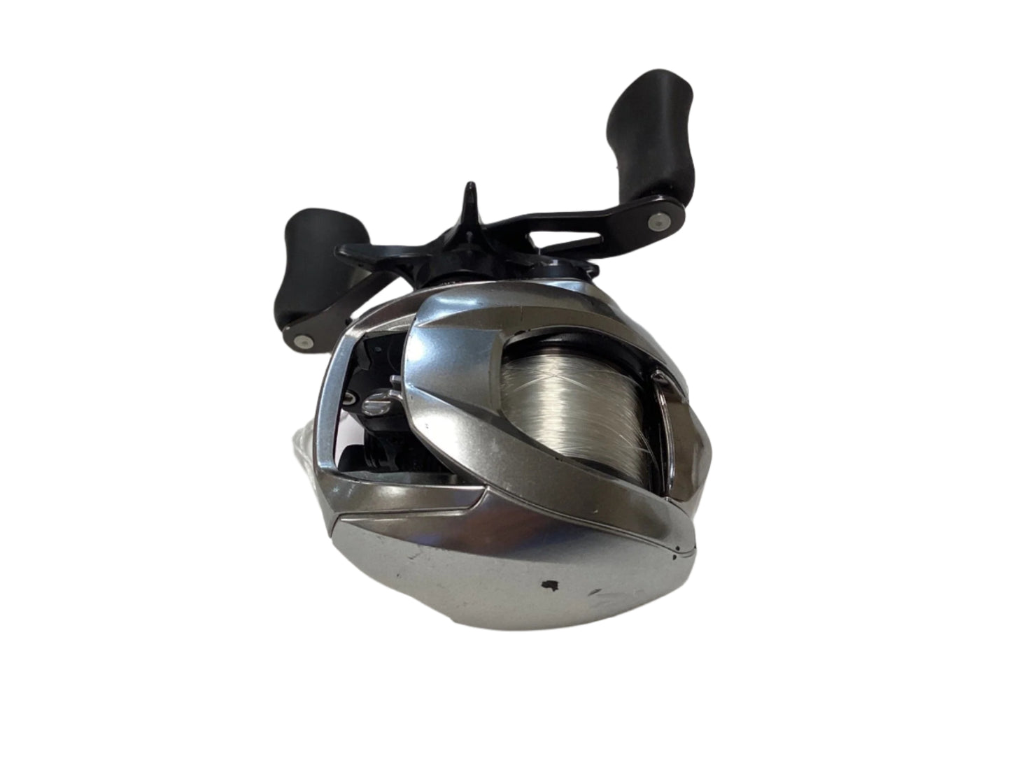 A Daiwa Zillion ZLNSVG100H used silver baitcasting reel with black dual handles and fishing line, shown on a white background—eligible for Rod and Reel Trade-In or new product warranty. Brand: Daiwa. Condition: Good.