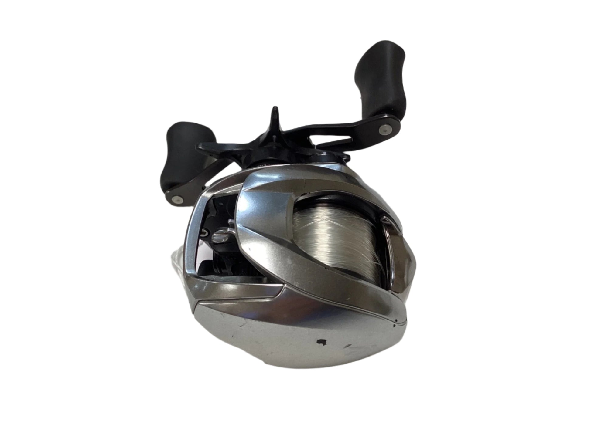 A Daiwa Zillion ZLNSVG100H used silver baitcasting reel with black dual handles and fishing line, shown on a white background—eligible for Rod and Reel Trade-In or new product warranty. Brand: Daiwa. Condition: Good.