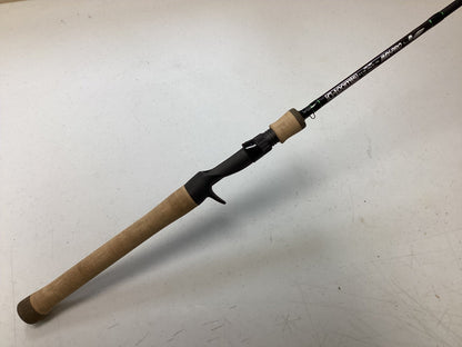 A G. Loomis IMX-Pro 752C SBR Used Casting Rod in excellent condition, featuring a cork handle and exposed reel seat, is displayed diagonally on a white surface—ideal for trade-in upgrades or buying quality used gear with store credit.