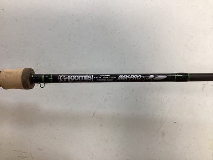 A G. Loomis IMX-Pro 752C SBR Used Casting Rod in excellent condition, showing specs and a cork handle, rests on a white surface. Ideal for our Rod and Reel Trade-In Program—exchange your used gear for store credit.