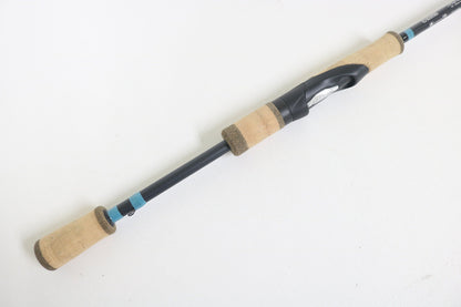 The G. Loomis NRX+ 782s SJR 6'6" Medium Used Spinning Rod, in excellent condition, features cork handles and a black reel seat—perfect for anglers seeking quality gear or exploring our Rod and Reel Trade-In program.