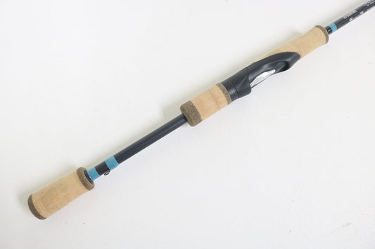 The G. Loomis NRX+ 782s SJR 6'6" Medium Used Spinning Rod, in excellent condition, features cork handles and a black reel seat—perfect for anglers seeking quality gear or exploring our Rod and Reel Trade-In program.