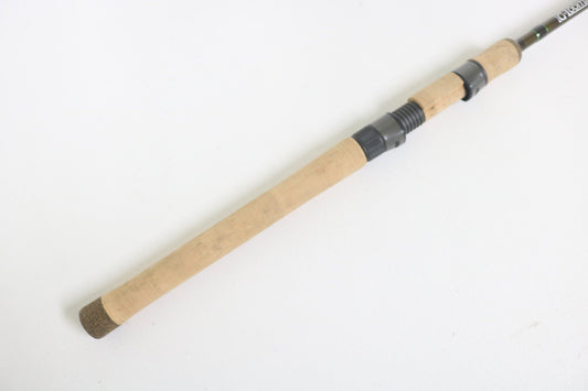 Close-up of the G. Loomis IMX-Pro 831s NRR 6'11" Medium Light spinning rod handle, showcasing a cork grip and black reel seat on a white background.