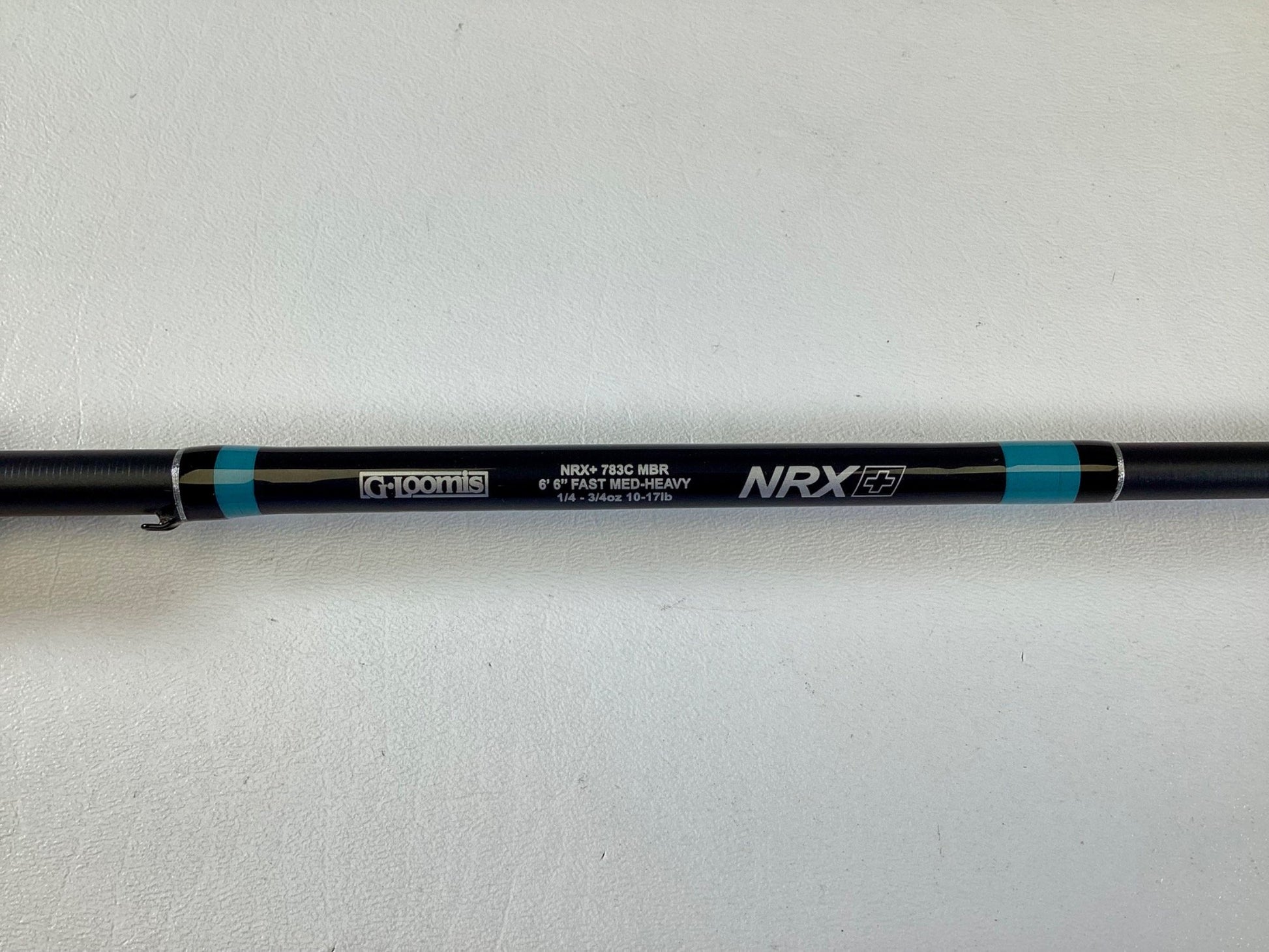 A close-up of a black G. Loomis NRX+ 783C MBR 6'6" Medium Heavy Casting Rod in excellent condition—ideal for upgrading through our Rod and Reel Trade-In Program.