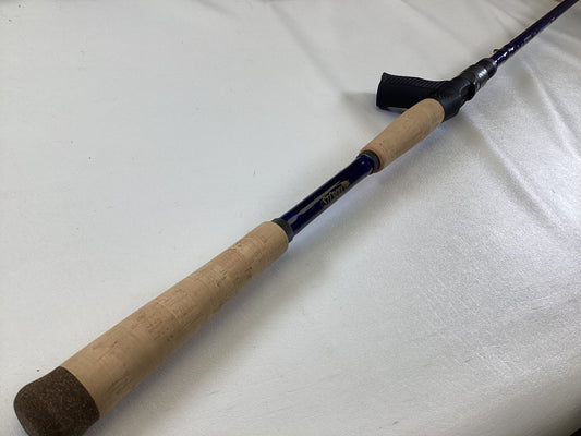 A close-up of the St. Croix Legend Tournament Musky Casting Rod Split Cork 8'3" Heavy Lipstick II—used, mint condition—shows its cork handle and blue shaft, ideal for our Rod and Reel Trade-In Program.