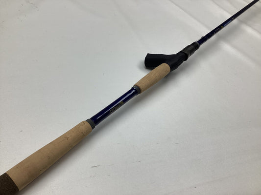 A St. Croix Legend Tournament Musky Casting Rod Split Cork 9'0" Medium Light Bantam Bait, in mint used condition, lies diagonally on a white surface—ideal for those interested in our Rod and Reel Trade-In program for Store Credit.