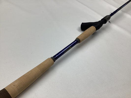 A St. Croix Legend Tournament Musky Casting Rod Split Cork 8'6" Medium Light Lil' Dawg in mint condition is placed diagonally on a white surface—ideal for anglers trading used gear or earning store credit with our Rod and Reel Trade-In program.