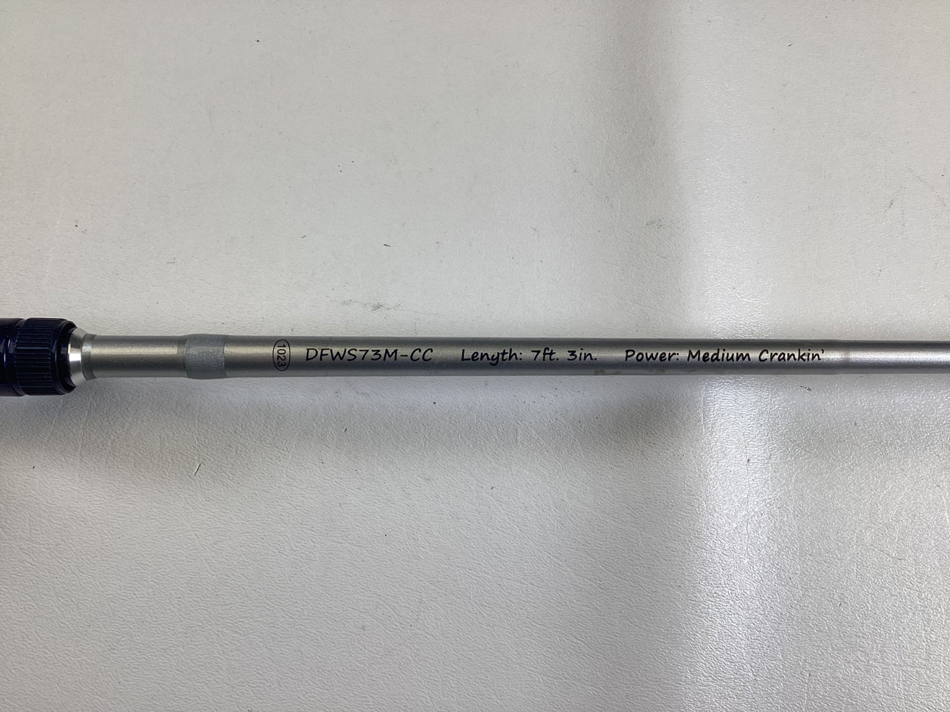 A close-up of the Duckett Jacob Wheeler Select DFWS73M-CC 7'3" Medium Crankin Used Casting Rod in excellent condition—ideal for our Rod and Reel Trade-In Program—shows product text on a light background.