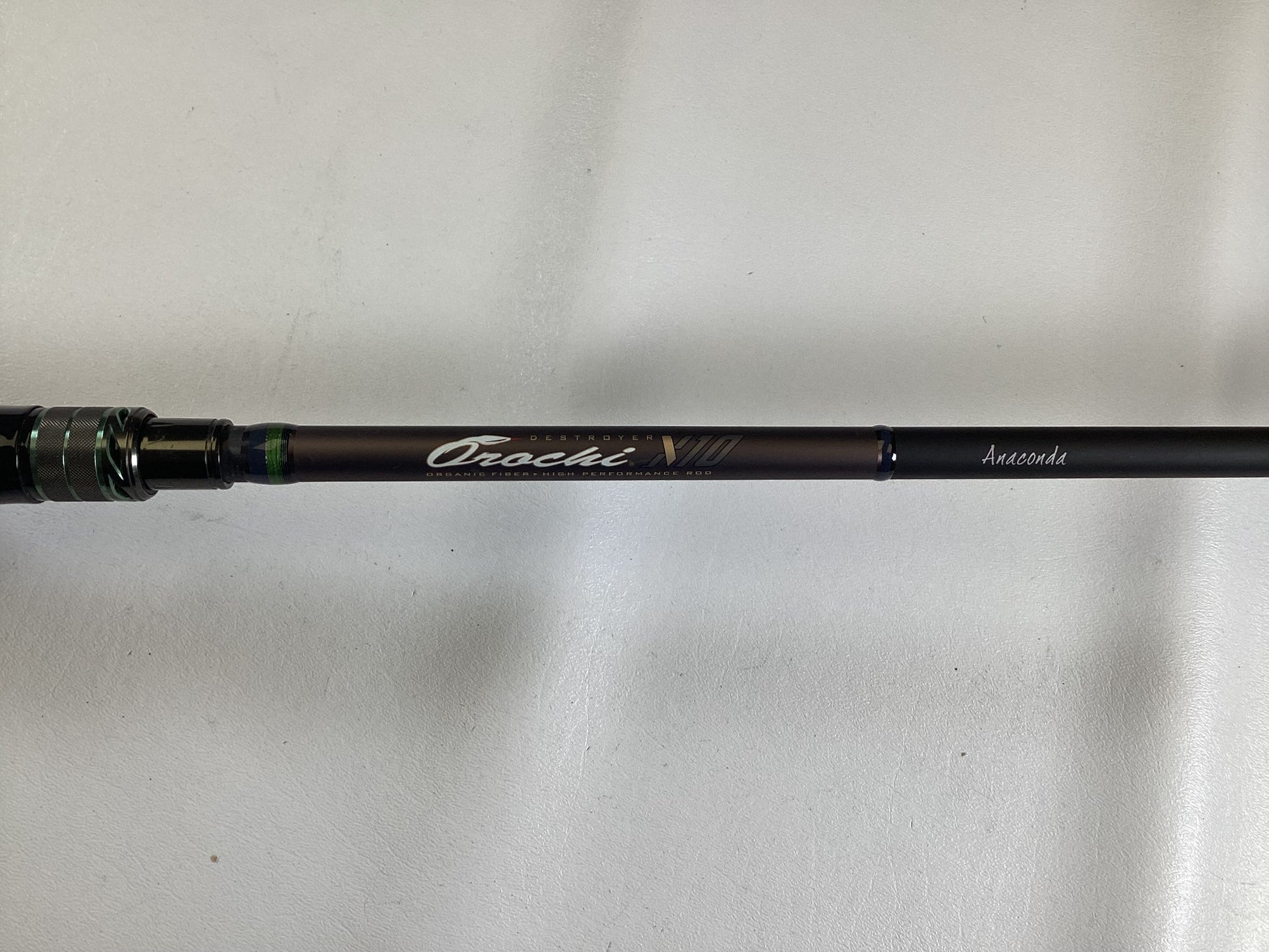 A close-up of a Megabass Orochi X10 F9-710XT Anaconda 7'10" XXH used casting rod in excellent condition—ideal for anglers or those trading in gear for store credit.