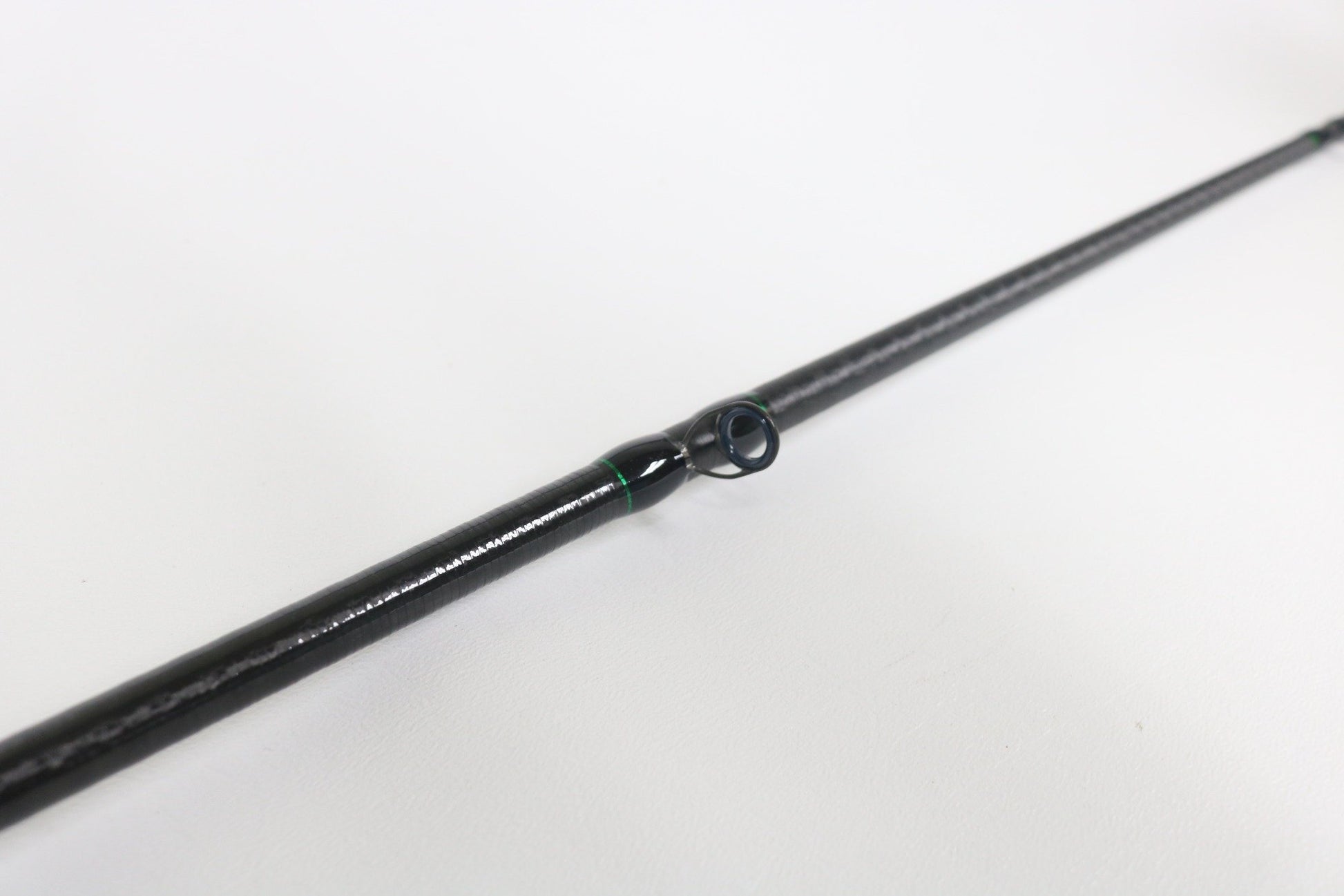 A close-up of a Shimano Curado CDC610LBFSGA 6'10" Light casting rod in excellent used condition highlights a line guide—perfect for those seeking quality used fishing gear or store credit with our rod and reel trade-in program.