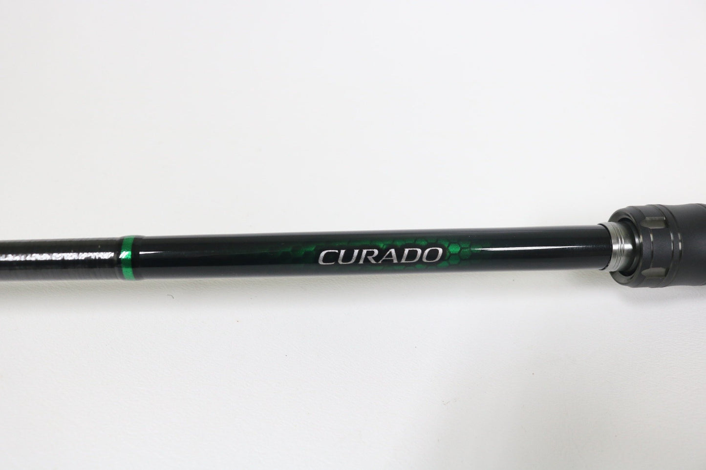 A close-up of a Shimano Curado CDC610LBFSGA 6'10" Light used casting rod in excellent condition, featuring bold "CURADO" branding on the shaft—ideal for those seeking quality used gear or a rod and reel trade-in.