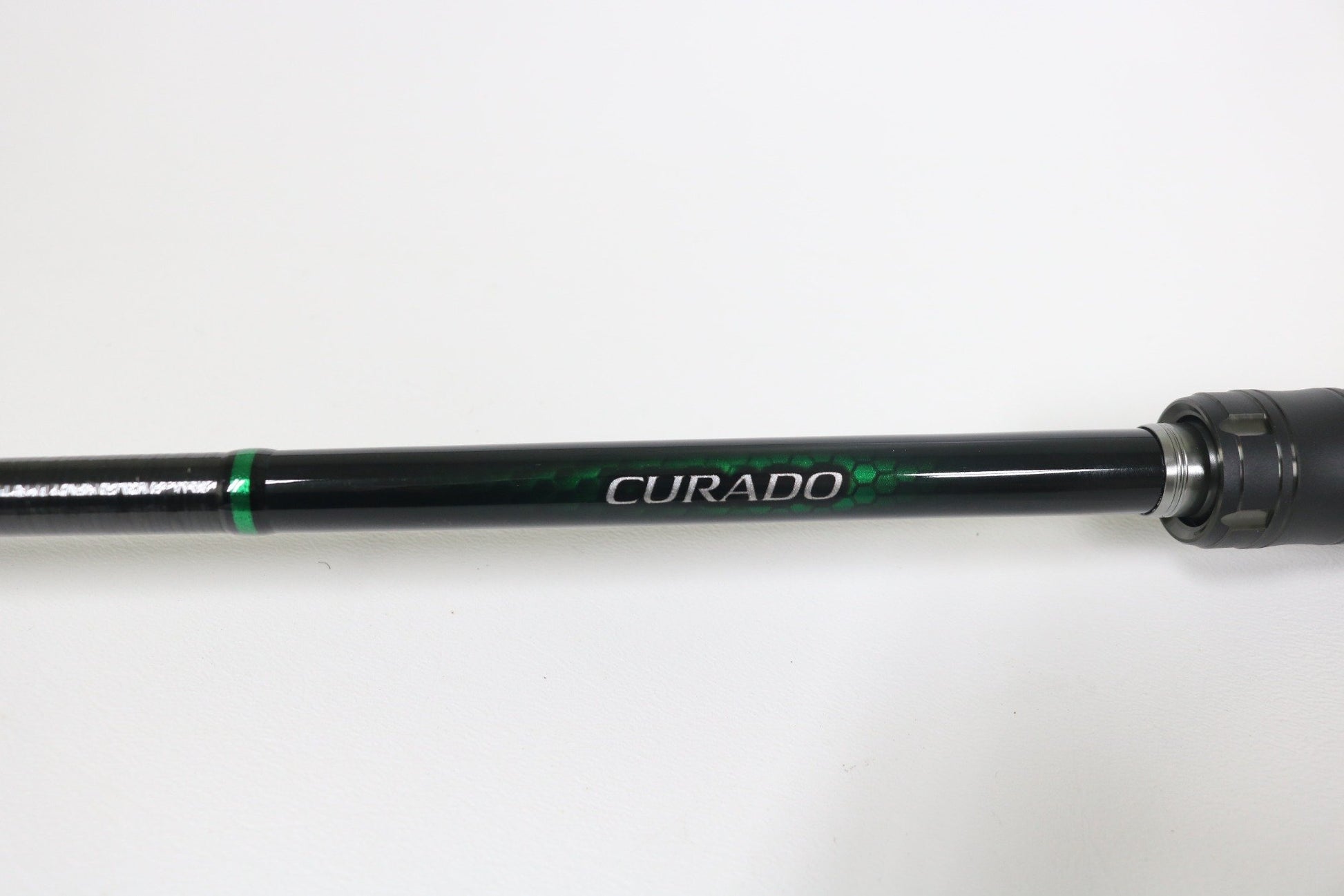 A close-up of a Shimano Curado CDC610LBFSGA 6'10" Light used casting rod in excellent condition, featuring bold "CURADO" branding on the shaft—ideal for those seeking quality used gear or a rod and reel trade-in.