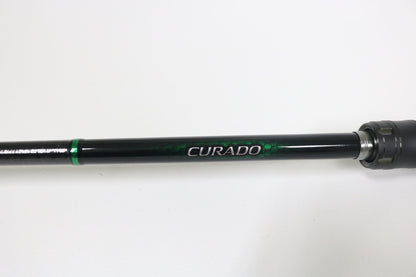 A close-up of a Shimano Curado CDC610LBFSGA 6'10" Light used casting rod in excellent condition, featuring bold "CURADO" branding on the shaft—ideal for those seeking quality used gear or a rod and reel trade-in.