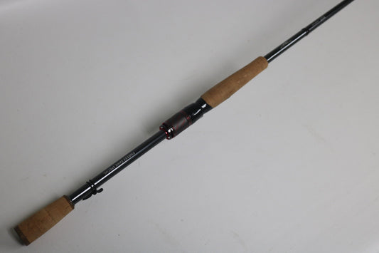 The Daiwa Steez AGS STAGS711MLFS 7'1" Medium Light spinning rod, with cork handles and black and red reel seat, rests diagonally on a white background. Trade in your used gear through our Rod and Reel Trade-In Program to earn store credit for your next adventure.