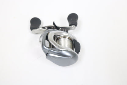 Shimano Curado I 200PG 5.5:1 Used Casting Reel in excellent condition, with black handle grips, shown on a white background. Eligible for Rod and Reel Trade-In—get store credit when you upgrade your used gear!.