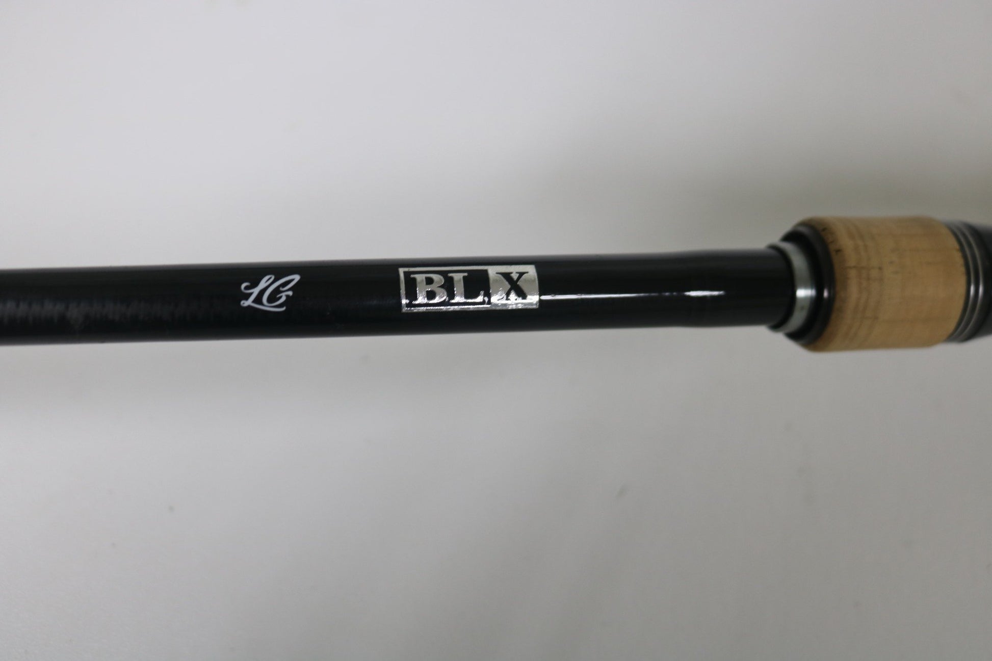 A close-up of the Daiwa BLX BLXLG741MHRB 7'4" Medium Heavy Used Casting Rod in excellent condition, with "BLX" marking and cork handle—perfect for upgrading via our Rod and Reel Trade-In Program.