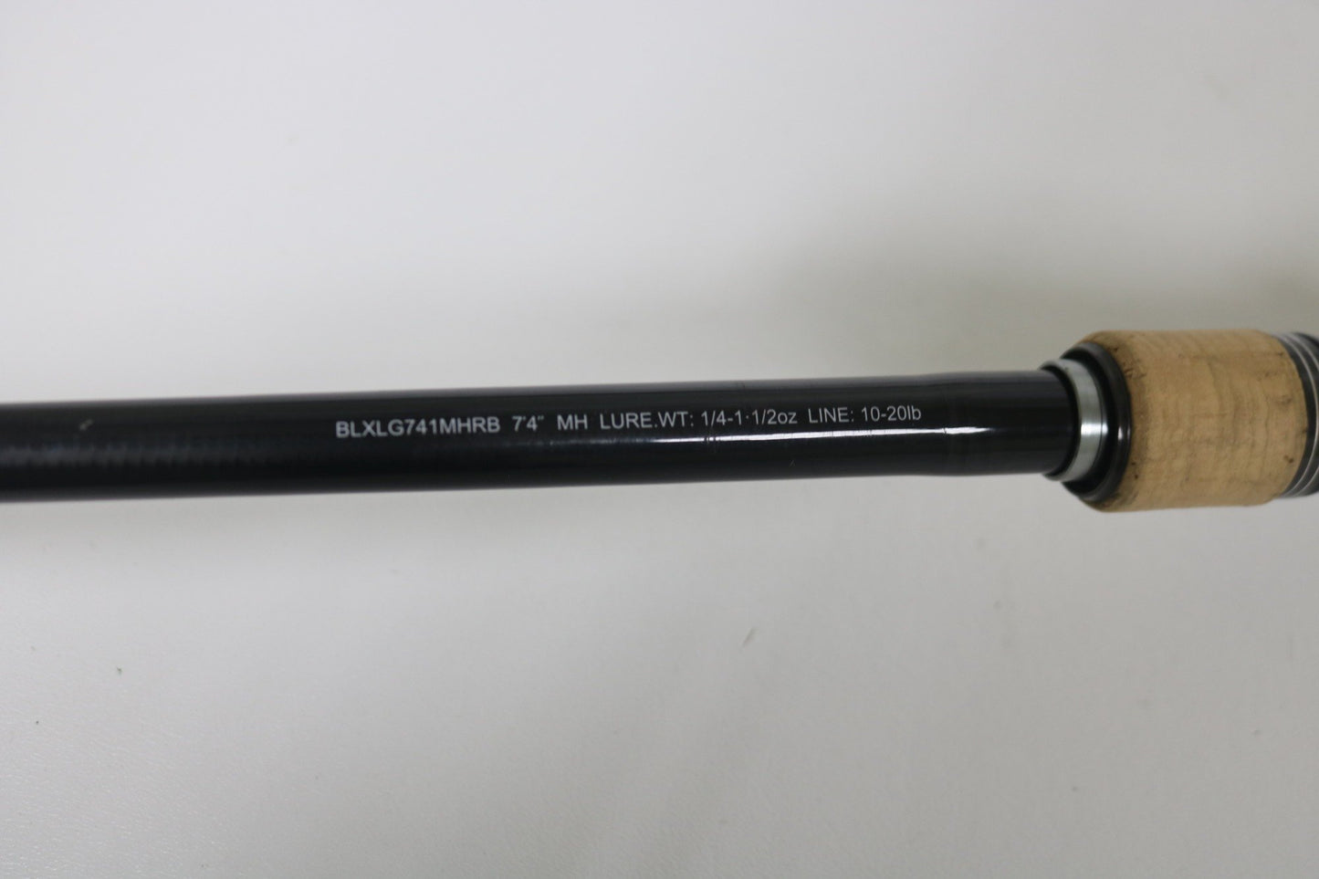 Close-up of Daiwa BLX BLXLG741MHRB 7'4" Medium Heavy casting rod in excellent used condition, model details in white, cork handle—perfect for our Rod and Reel Trade-In Program to earn store credit for your used gear.