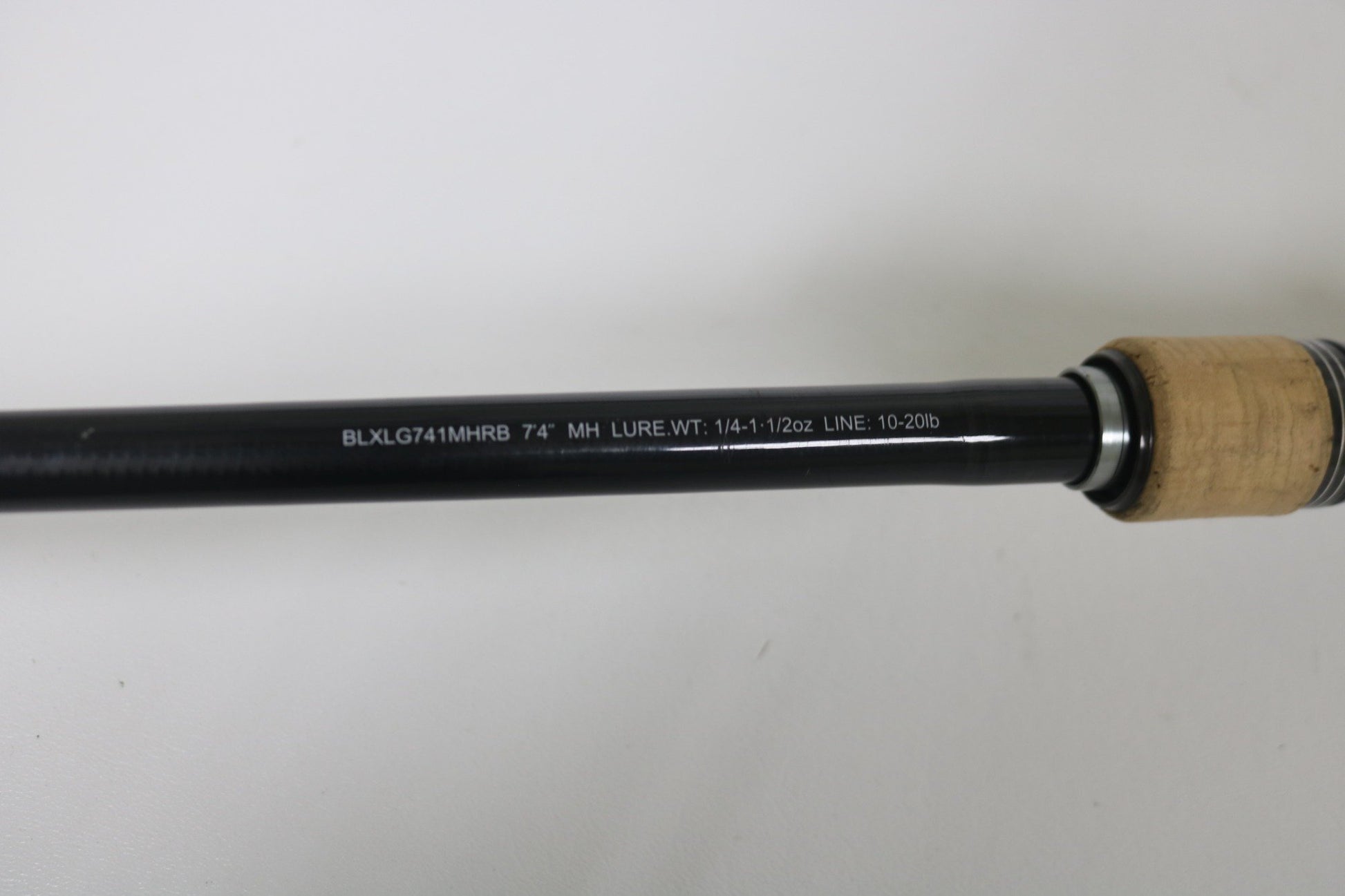 Close-up of Daiwa BLX BLXLG741MHRB 7'4" Medium Heavy casting rod in excellent used condition, model details in white, cork handle—perfect for our Rod and Reel Trade-In Program to earn store credit for your used gear.
