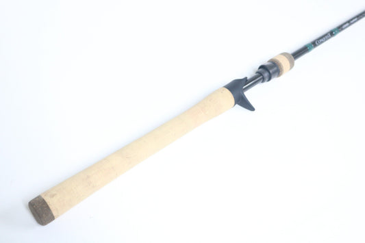 A G. Loomis Conquest CNQ 843C MBR Used Casting Rod in mint condition, shown with a cork handle and black reel seat—ideal for trading in through our Rod and Reel Trade-In Program to upgrade your gear and earn store credit.