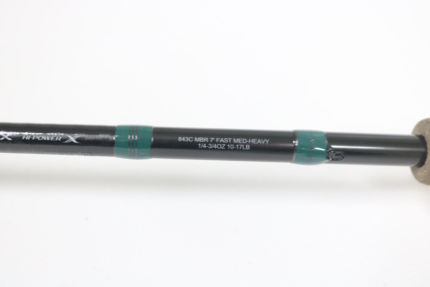 Close-up of the G. Loomis Conquest CNQ 843C MBR Used Casting Rod in mint condition, featuring white specs on a black rod with green accents and cork handle—ideal for our Trade-In Program to earn store credit on used gear.