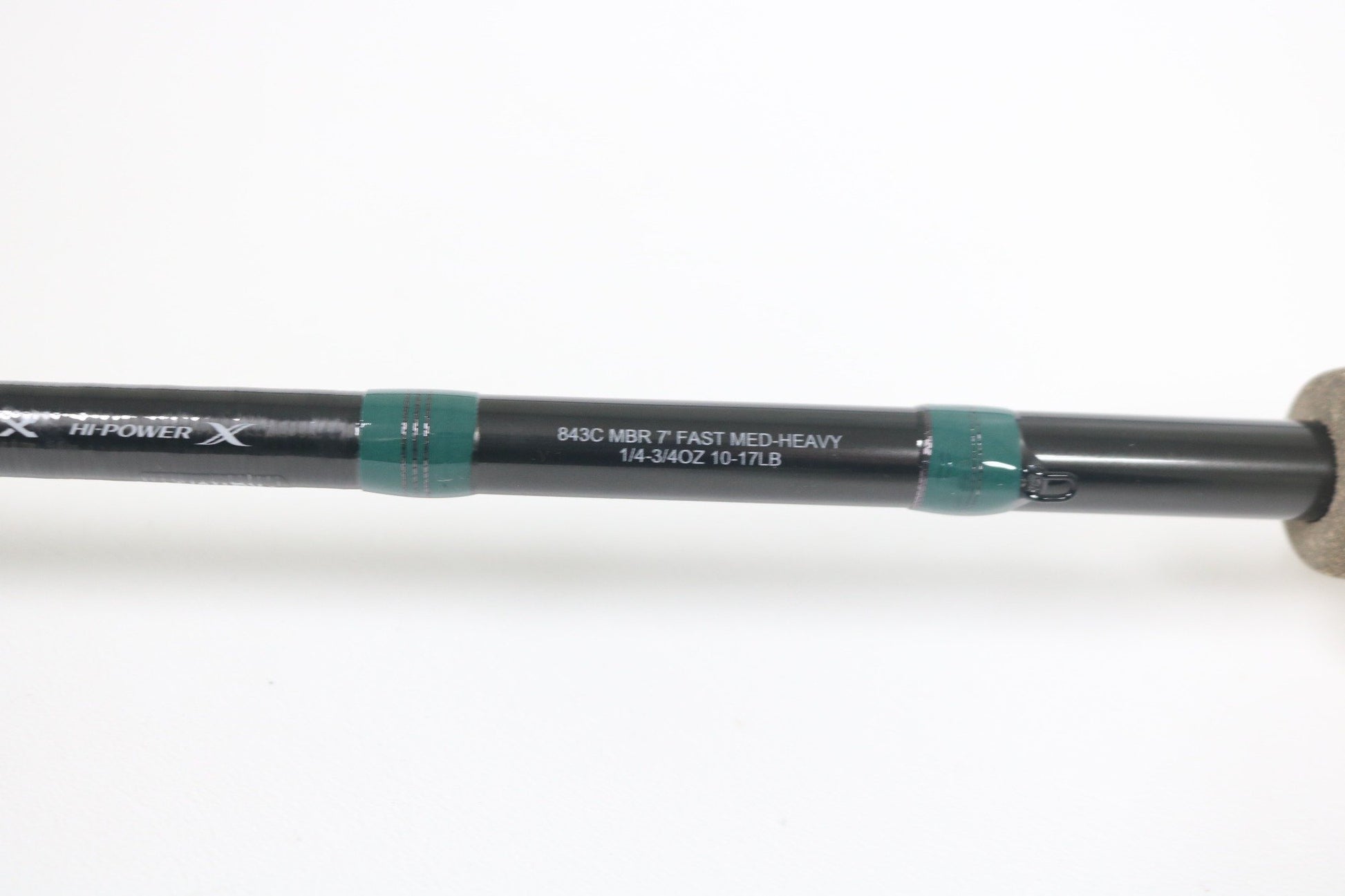 Close-up of the G. Loomis Conquest CNQ 843C MBR Used Casting Rod in mint condition, featuring white specs on a black rod with green accents and cork handle—ideal for our Trade-In Program to earn store credit on used gear.