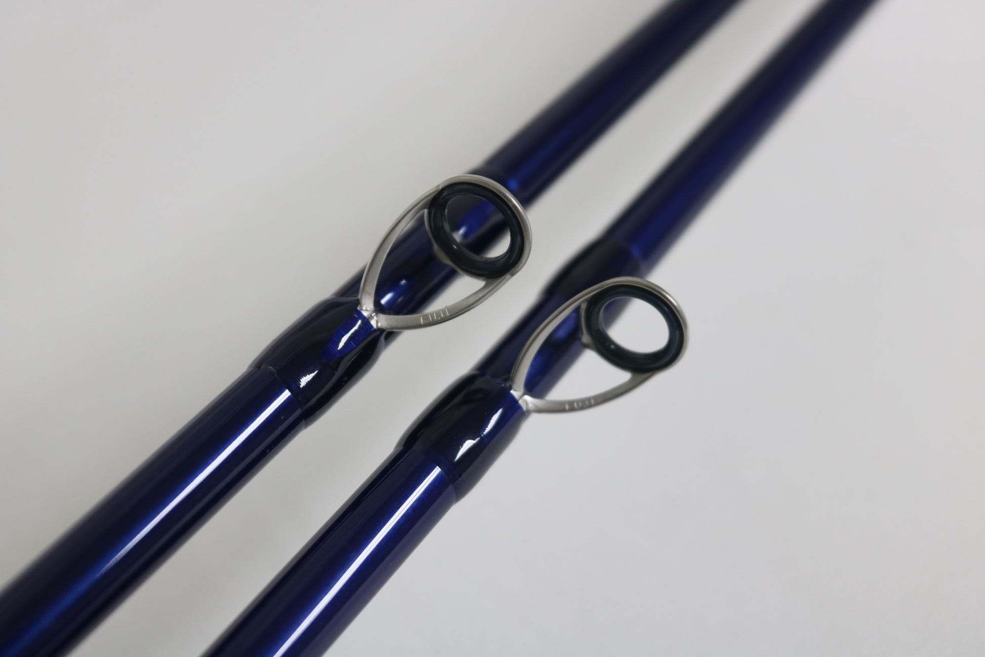 Close-up of two Douglas LRS C 704M Casting Rod tips with metal guides on a light background—ideal for anglers seeking an upgrade or using store credit on these used, very good condition rods.