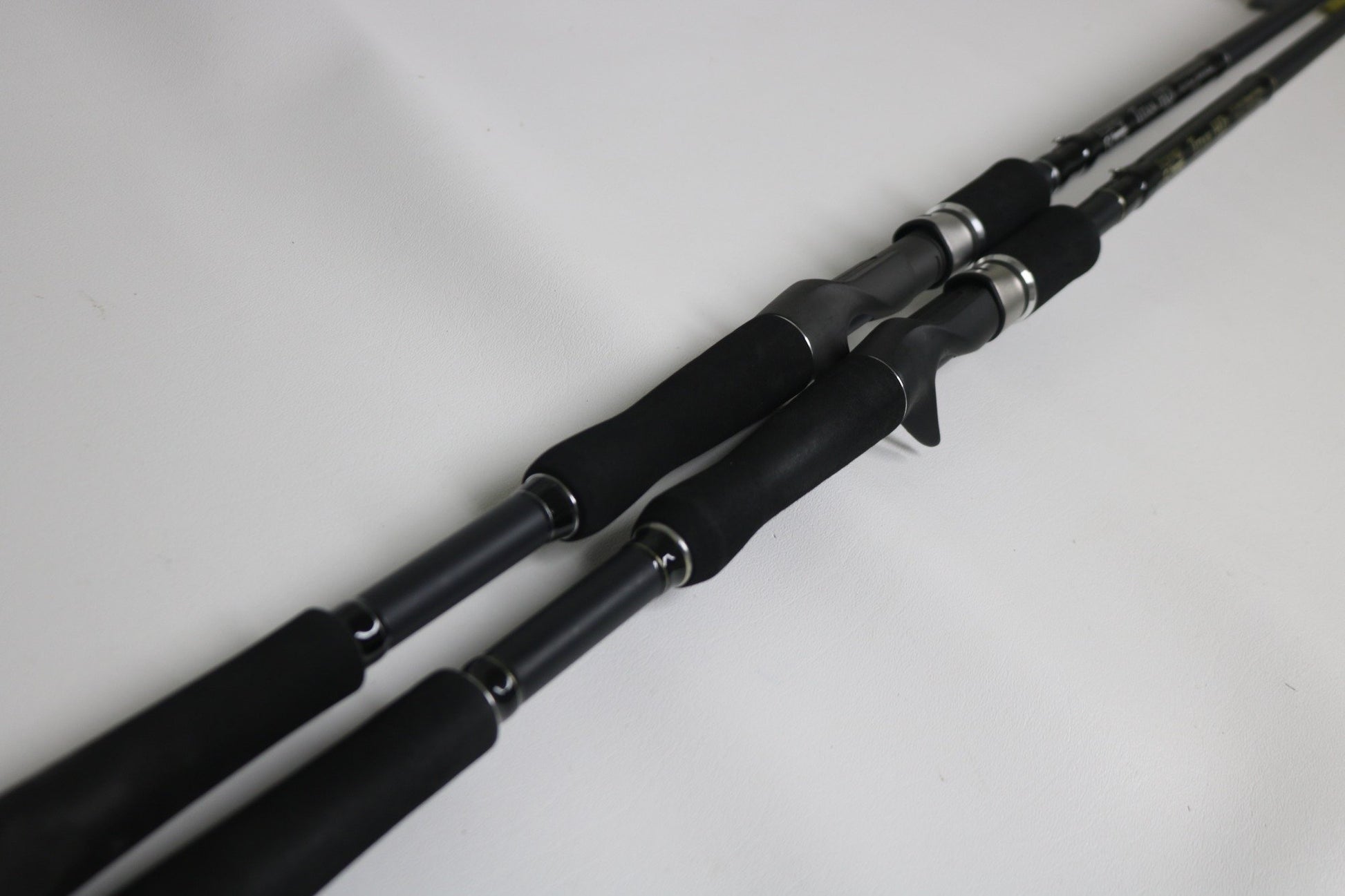 Two Fitzgerald Titan HD THD76H and THD76XH Casting Rods (Used, Very Good Condition) by Fitzgerald, shown side by side—ideal for those exploring our Rod and Reel Trade-In program for store credit.