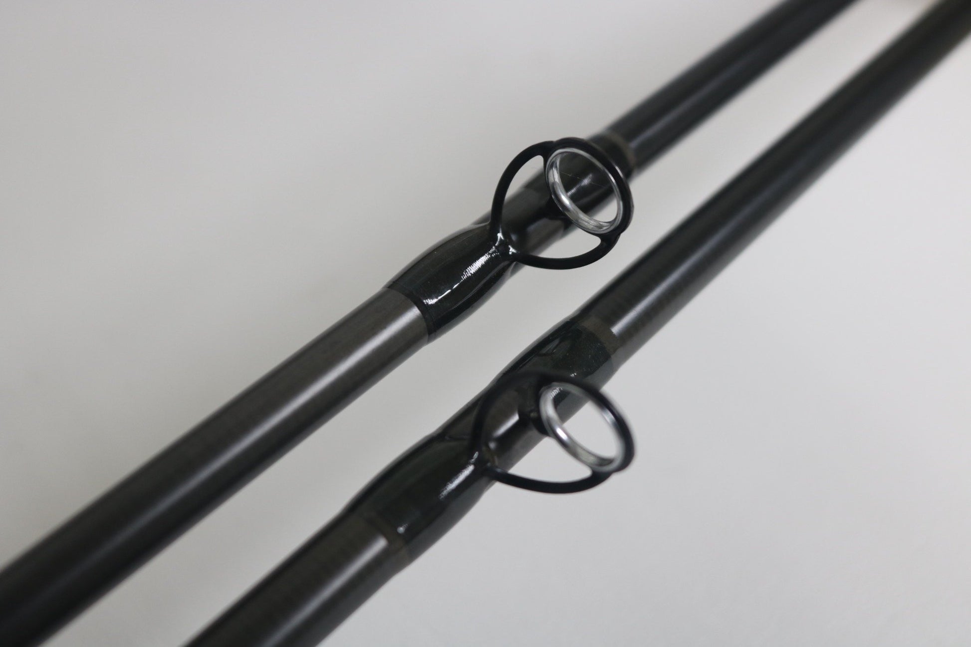 Close-up of two Temple Fork GTS Bass C735-1 and TPM CB 745-1 casting rods in good used condition, placed parallel to show line guides—ideal for anglers seeking quality used Temple Fork gear.