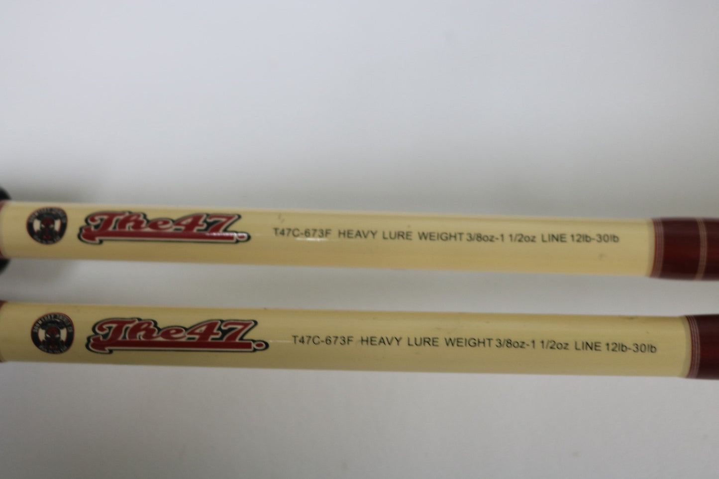 Two beige Doomsday The47 T47C-673F Casting Rods (used, fair condition) are displayed side by side on a white background—ideal for anglers considering our Rod and Reel Trade-In or store credit on used gear.