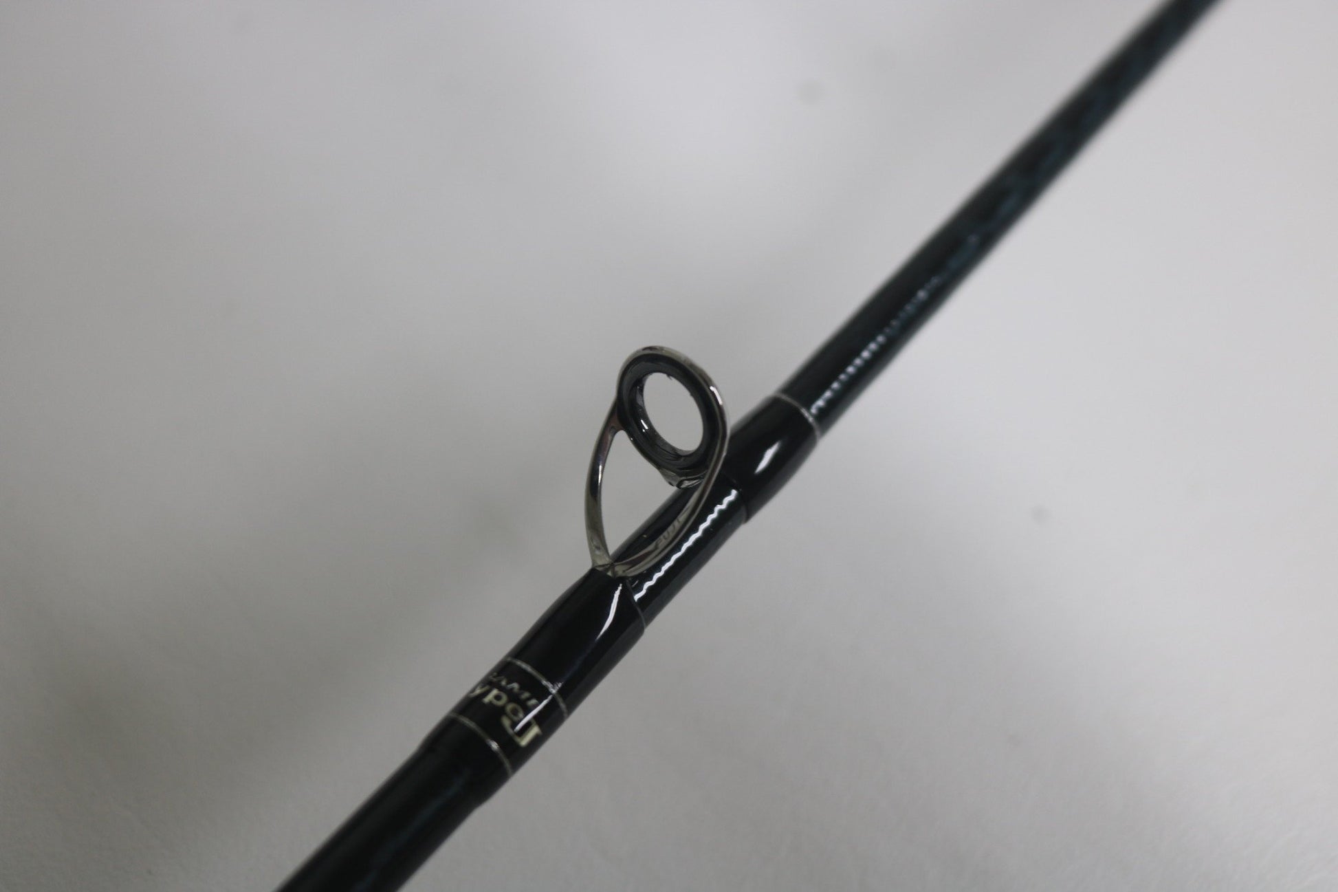 Close-up of a Shimano Game Type J 6'0" used casting rod in excellent condition, highlighting its metal line guide against a white background—ideal for the Rod and Reel Trade-In Program.