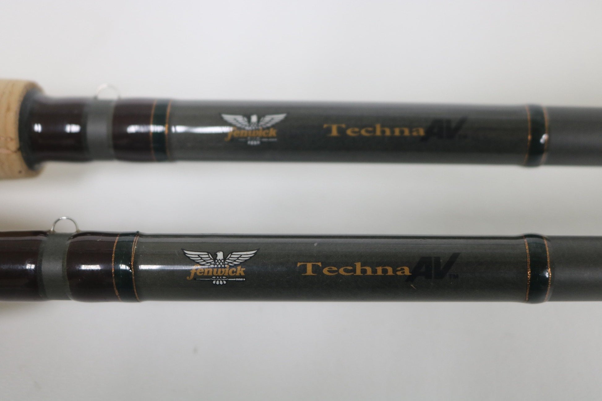 Close-up of two Fenwick Techna AV AVC79HF and AVC71HF Casting Rods in very good used condition, featuring visible branding and detailing—a great choice for those interested in quality pre-owned gear.