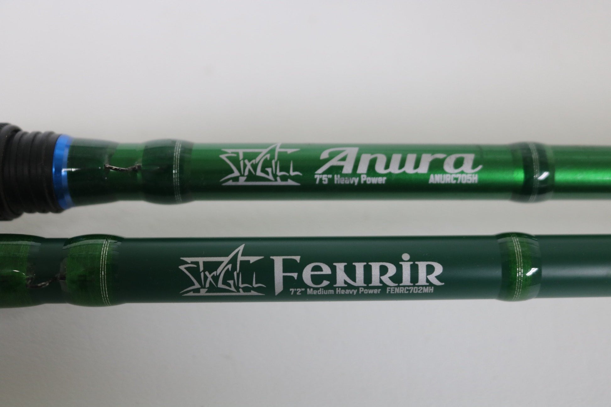 Two green SixGill casting rods, Aura ANURC705H and Fenrir FENRC702MH, Used - Very Good Condition, are shown side by side—great choices for those seeking quality pre-owned gear or planning a Rod and Reel Trade-In for store credit.