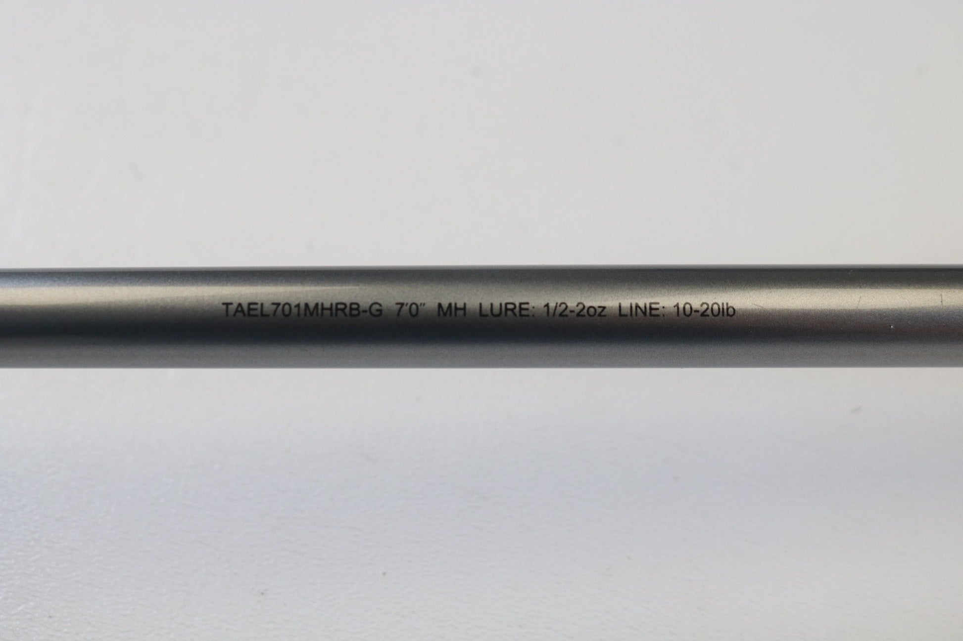 A close-up of the Daiwa Tatula Elite TAEL701MHRB-G 7'0" MH Glass Used Casting Rod, text reads "LURE: 1/2-2oz LINE: 10-20lb," perfect for those using store credit from our rod and reel trade-in program.