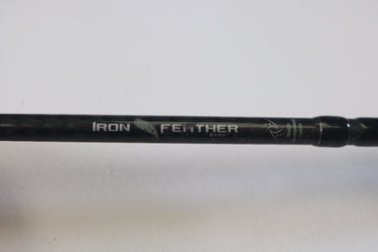 A close-up of a Waft Iron Feather 7'0" Medium Heavy Used Casting Rod in good condition—ideal for anglers seeking quality used gear or considering our Rod and Reel Trade-In for store credit. "IRON FEATHER BASS" is printed in white with a feather graphic on the rod.