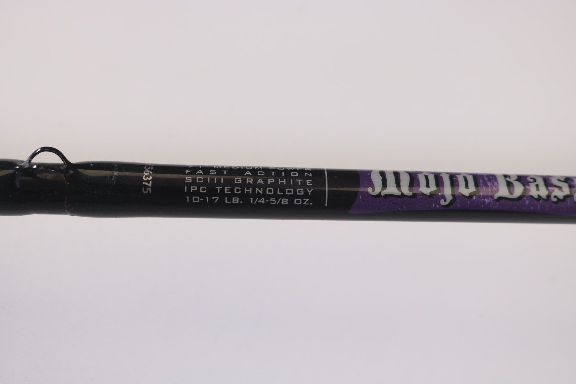 Close-up of a St. Croix Mojo Bass MJC71MF Plastics 7'1" rod in black and purple, displaying "Fast Action," "SCIII Graphite," "IPC Technology," and "10-17 lb. 1/4-5/8 oz." Perfect for our Rod and Reel Trade-In Program to earn store credit on used gear.