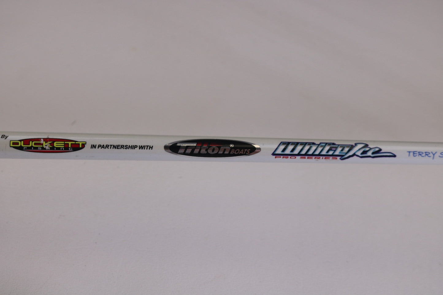 A close-up of a used Duckett White Ice TR-DFWI68MHS 6'8" Medium Heavy spinning rod in good condition. Great for those trading in used gear or earning store credit with our Rod and Reel Trade-In program.